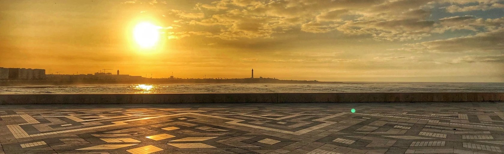 View from the paved area overlooking the sea with a cityscape on the far side