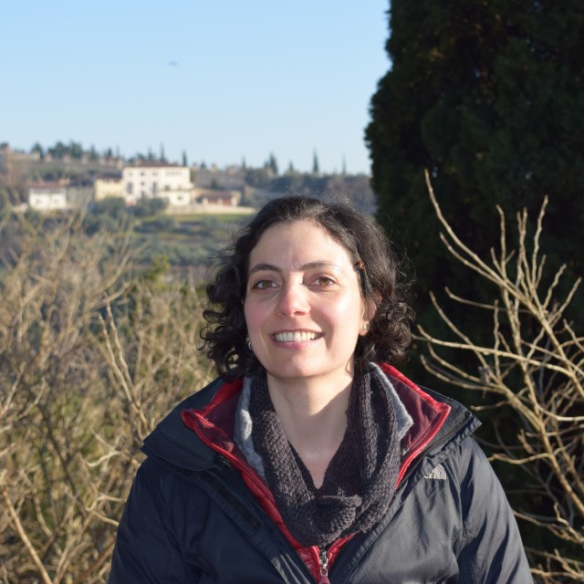 Headshot of Tiziano Lembo in front of bushes and a tree, with buildings in the far background