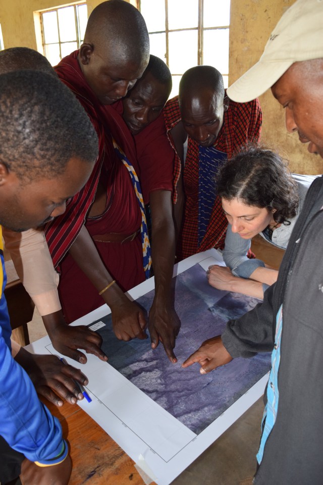 Focus On Tracking the movement of livestock - group of people studying a map